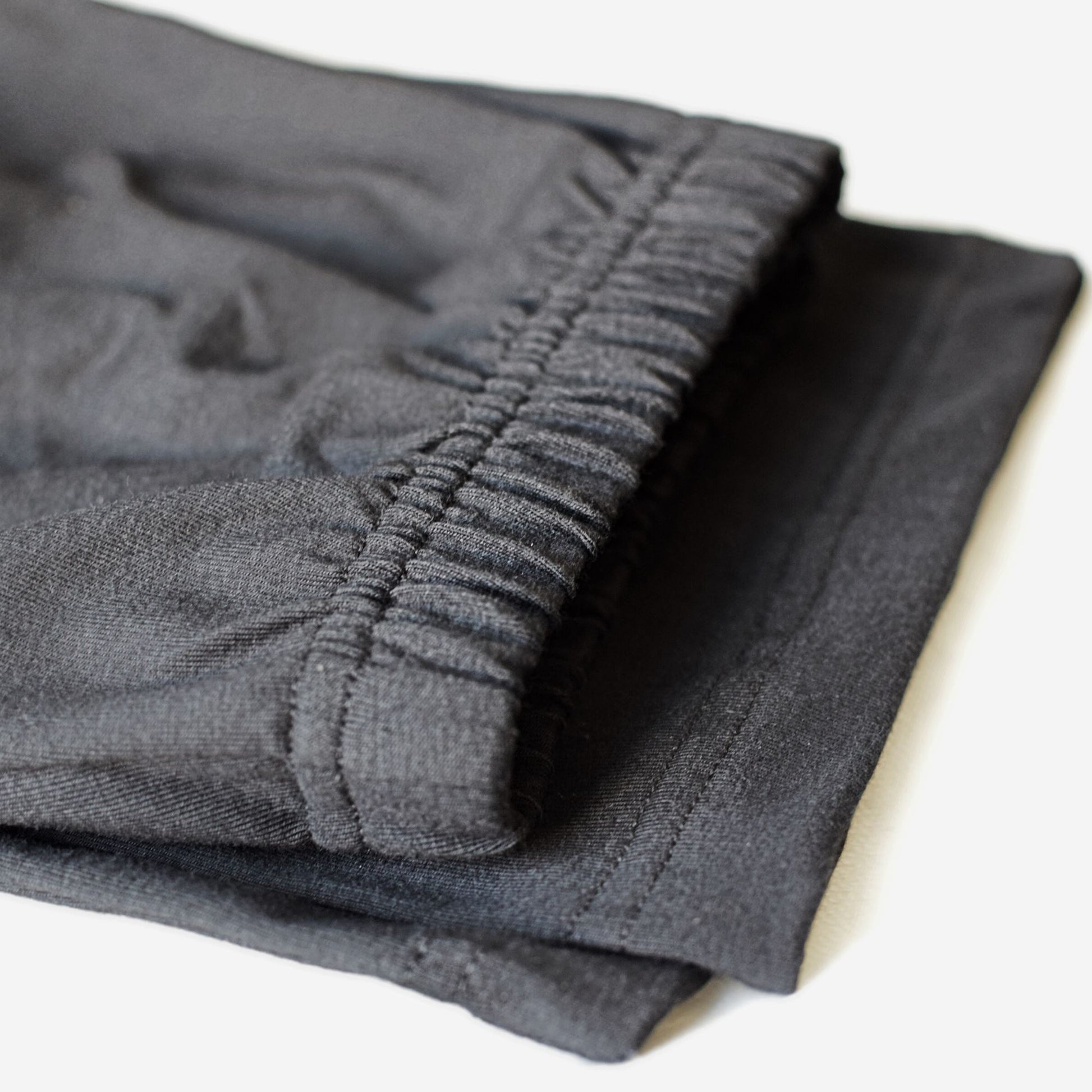 Folded straight leg cotton pants with non-roll elastic waist.