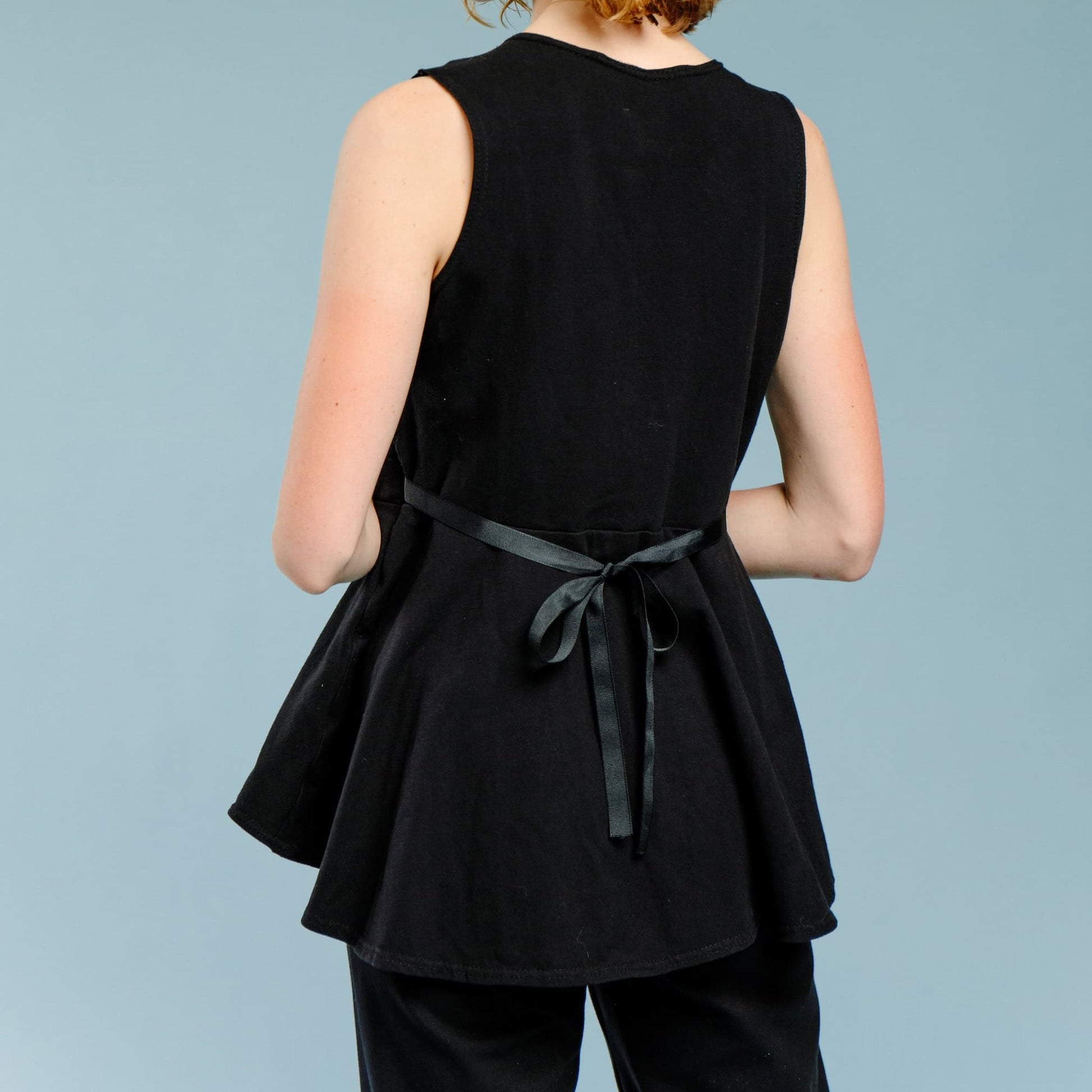 Back view of mastectomy camisole showing ribbon side ties for various bust sizes