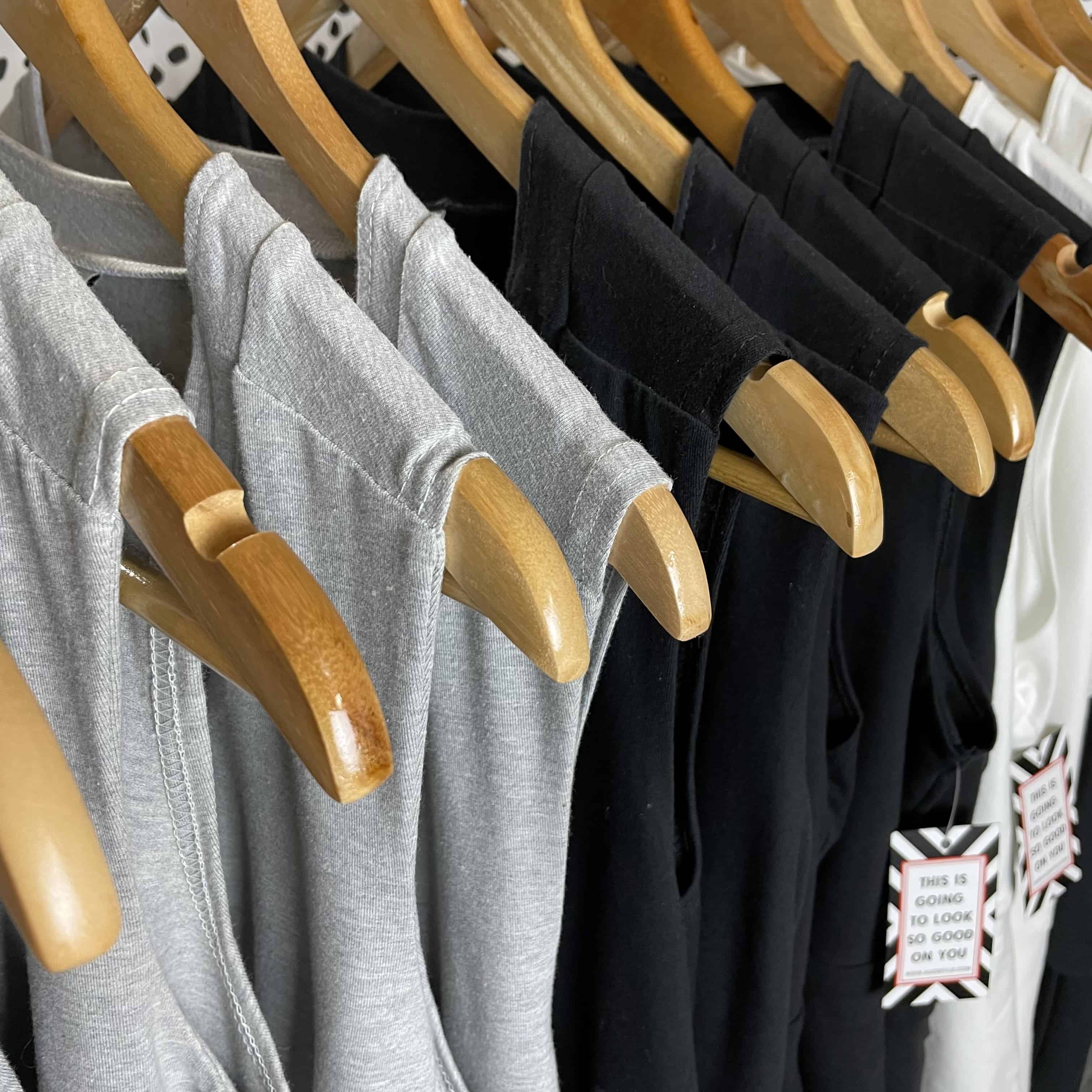 Mastectomy clothing hanging on garment rack.