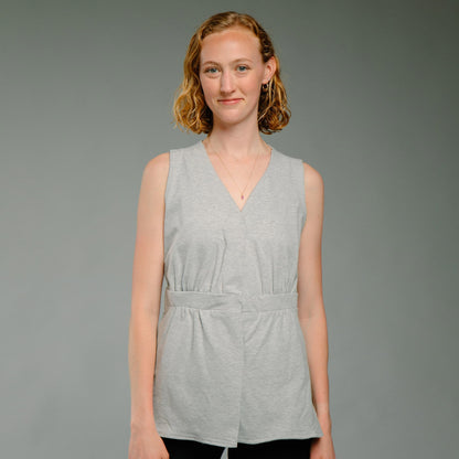 Woman wearing a heather gray sleeveless mastectomy camisole.