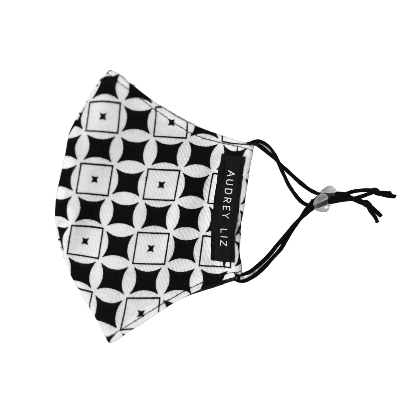 Cloth face mask in a black and white geometric print, with adjustable elastic ear loops.