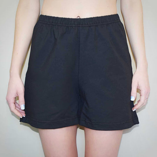 Solid black women’s shorts with elastic waist.